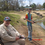 Dad giving Daniel some fishing tips.