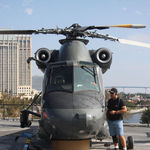 Pat standing next to a helicopter on the deck of the USS Midway.