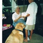 Blake giving Wannie her birthday cake, with Henry the dog waiting for a piece!