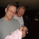 Billy views over the shoulder of his brother, Dale, to view his two month old grand niece Victoria.