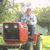 Julian  testing his repaired mower at my house. 