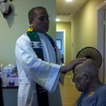 Dad being blessed by his son, Fr. Rodel