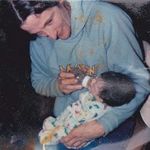 Doug feeding his youngest daughter Amanda.