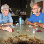 Walter and Dad at the kitchen table talking during poker game