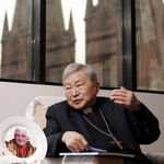 Bishop Aloysius Jin Luxian, the official Communist Party-recognized bishop of Shanghai, talks to a reporter, sitting near the plate printed with a portrait of Pope Benedict XVI on May 26, 2005 in Shanghai, China. Catholic news service AsiaNews says Shanghai bishop Aloysius Jin Luxian has died in China. He was 97. Aloysius Jin Luxian