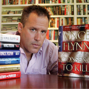 In a Sept. 2, 2005 file photo, best-selling author Vince Flynn poses with the dust jacket of his new book, "Consent to Kill," and copies of his six other books in his home in Edina, Minn. Flynn died, Wednesday, June 18, 2013, after a two-year battle with prostate cancer, a statement from Flynn's publisher, Simon & Schuster, Inc., said. He was 47.