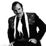 This 1980 file photo originally provided by Epic Records shows country singer Slim Whitman. Whitman died Wednesday, June 19, 2013 of heart failure in Florida. He was 90. Whitman's career began in the late 1940s, and his tenor falsetto and ebony mustache and sideburns became global trademarks. They were also an inspiration for countless jokes thanks to the ubiquitous 1980s and 1990s TV commercials that pitched his records. Slim Whitman