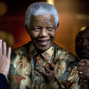In this Oct. 6, 2007 file photo, former South African President Nelson Mandela reacts as German Chancellor Angela Merkel, left, waves farewell after a meeting at the Nelson Mandela Foundation building in Johannesburg, South Africa. Former South African President Nelson Mandela has been hospitalized with a stomach ailment, according to a government statement issued Saturday Feb. 25, 2012 about the 93-year-old anti-apartheid icon.