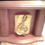 The urn of Janice's cremains that her widower husband, Daryl has...with the music treble clef on it. Janice used her musical talents to Praise The Lord.