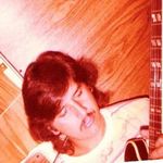 	This photo was taken in 1978 while parked in his mother’s driveway—Andy sitting inside his Van and playing his guitar.                 