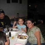 Rebecca and Isabella eating steak and carrot cake for the party held in Luis's honor.