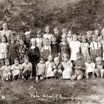 The student standing in front of the teacher is Esther