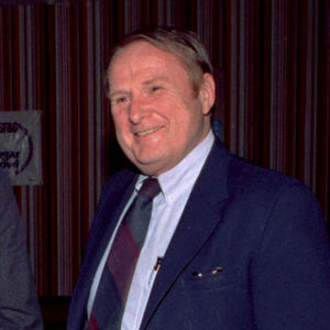 In this December 1990 file photo, Mickey Holmes, right, executive director of the Sugar Bowl, and Virginia football coach George Welsh talk with reporters at a news conference in New Orleans. Holmes, who was executive director of the bowl game from 1979 to 1993, died Wednesday, Sept. 8, 2010.